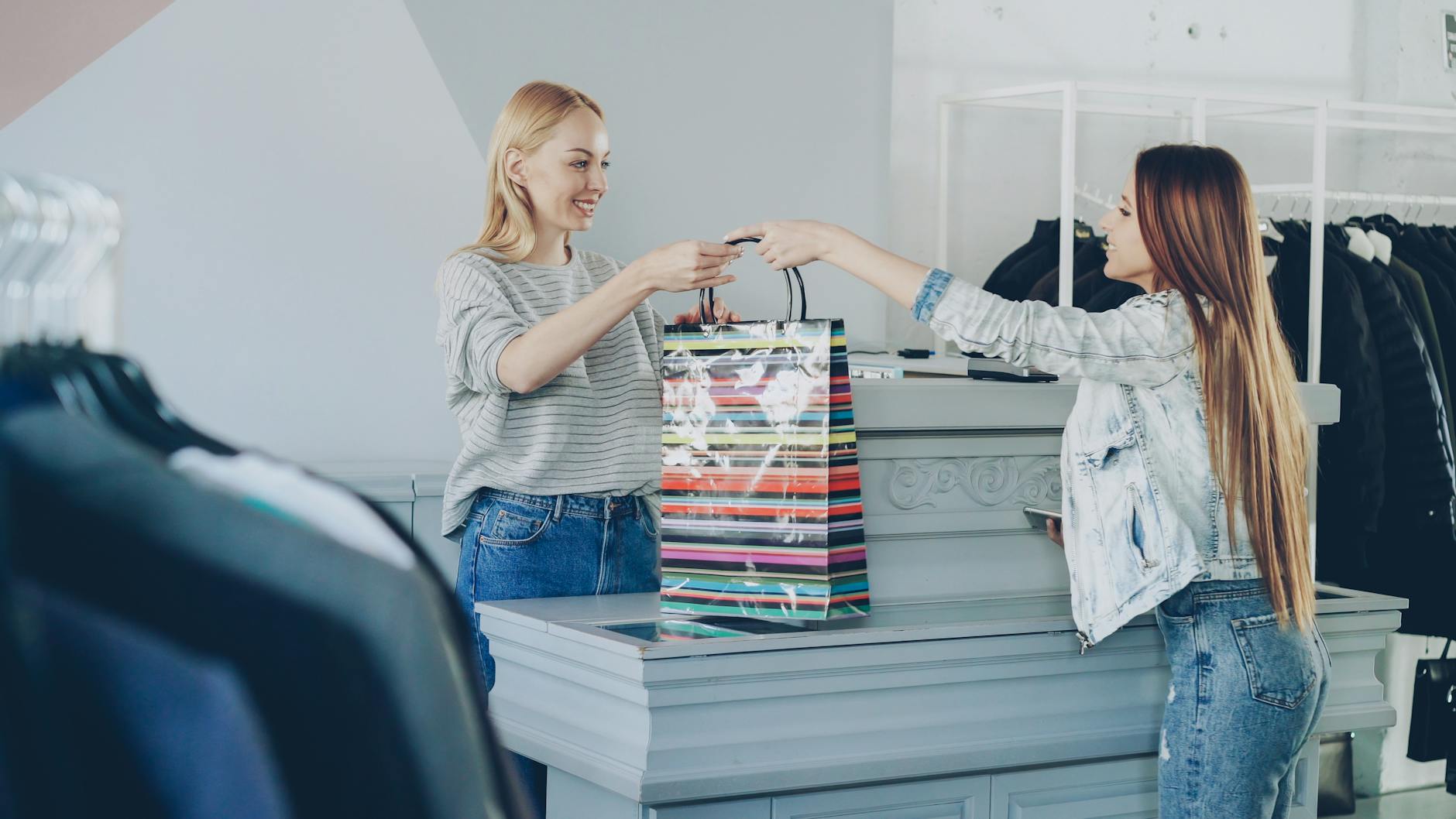 Person shopping with bags representing impulse spending and consumer psychology