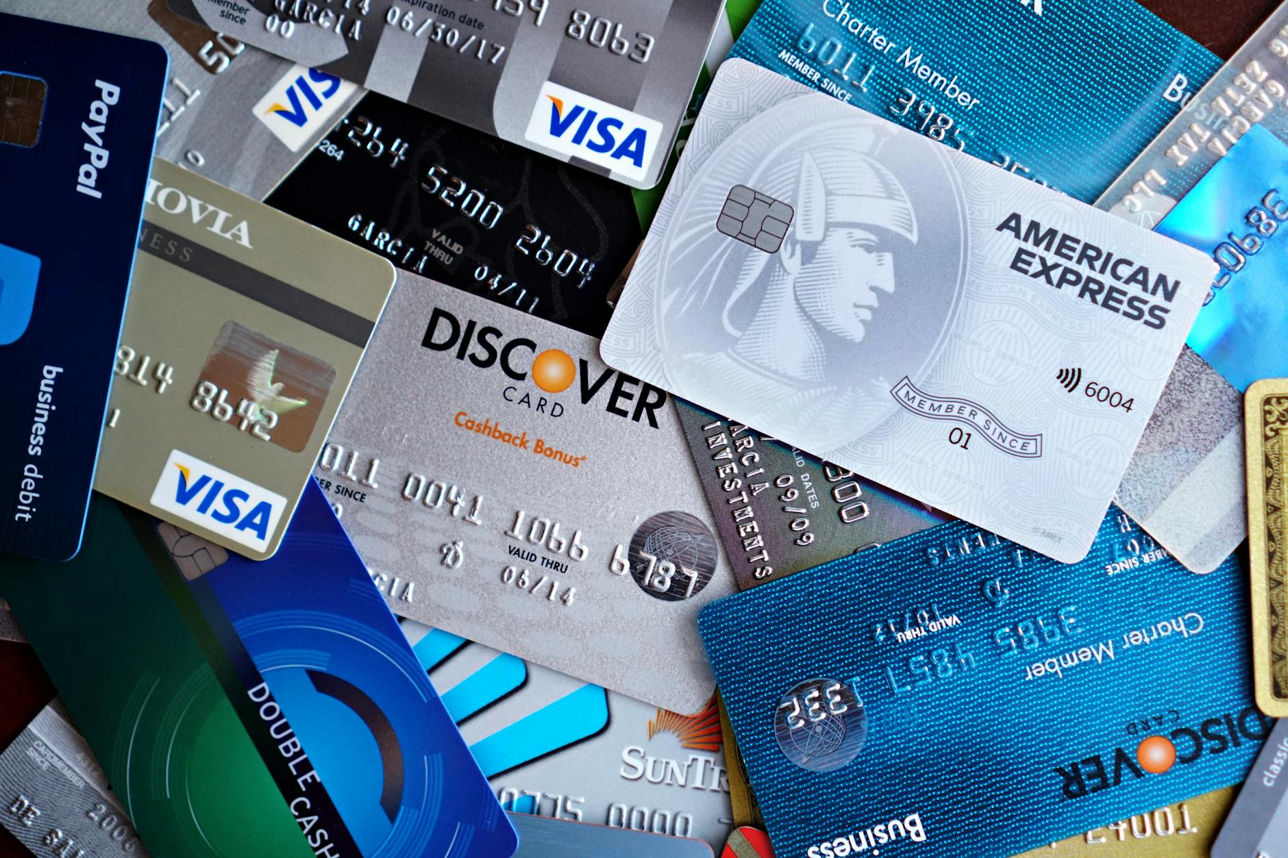 Multiple credit cards laid out on a desk with a calculator and notebook, representing balance transfer planning