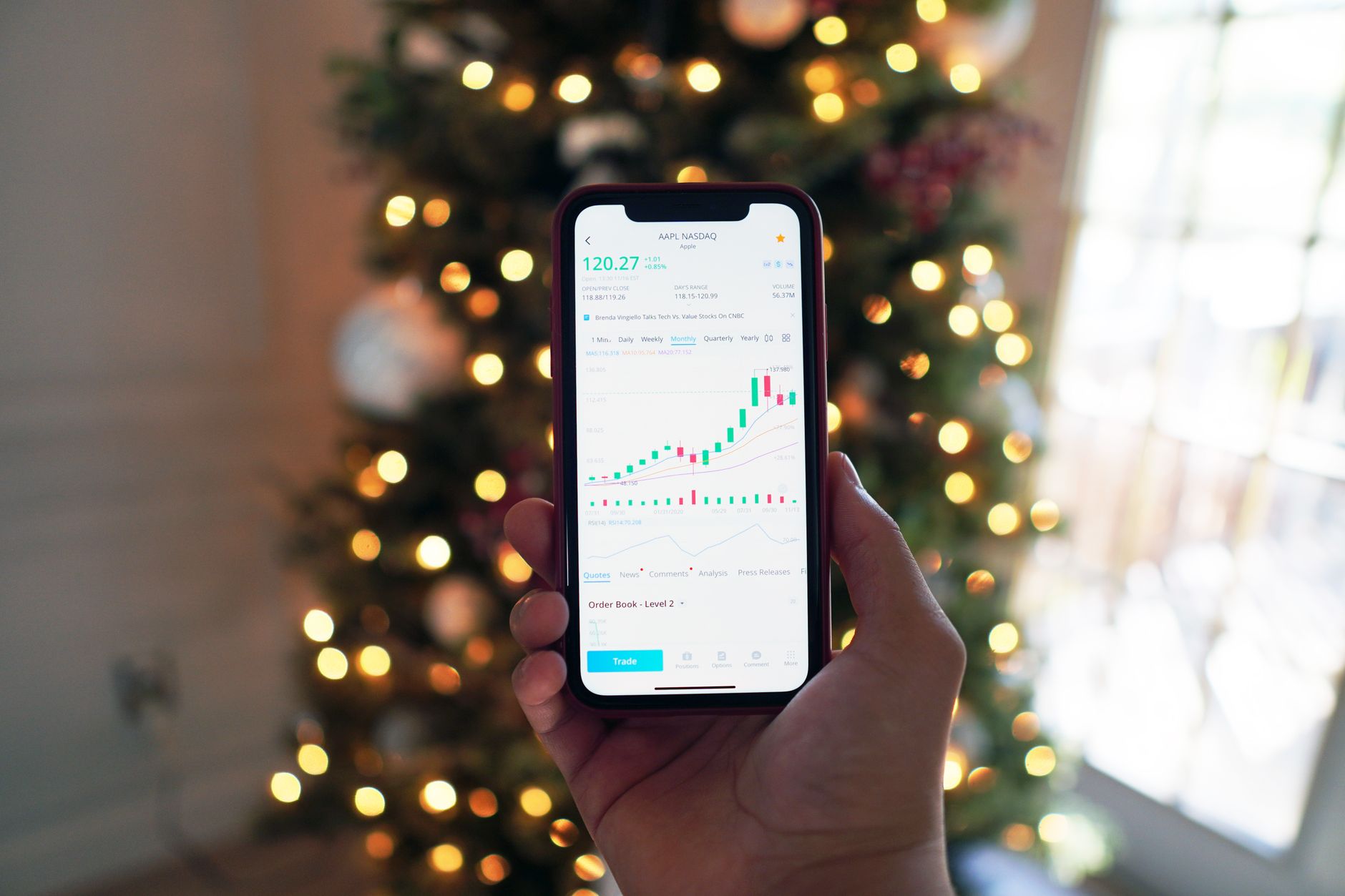 Person using a smartphone investing app to manage a portfolio