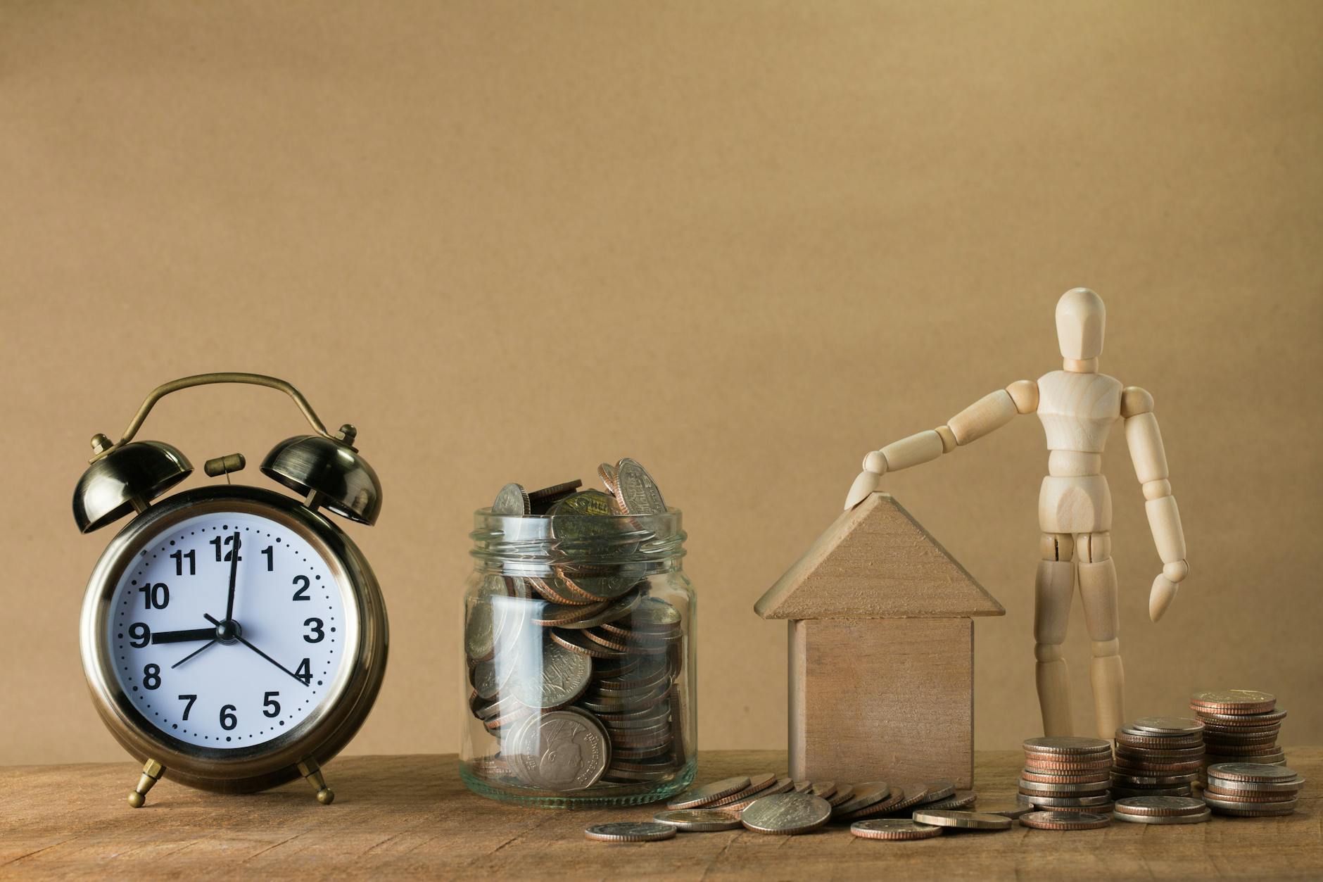 Coins and a savings jar representing retirement contributions to a Roth or Traditional IRA