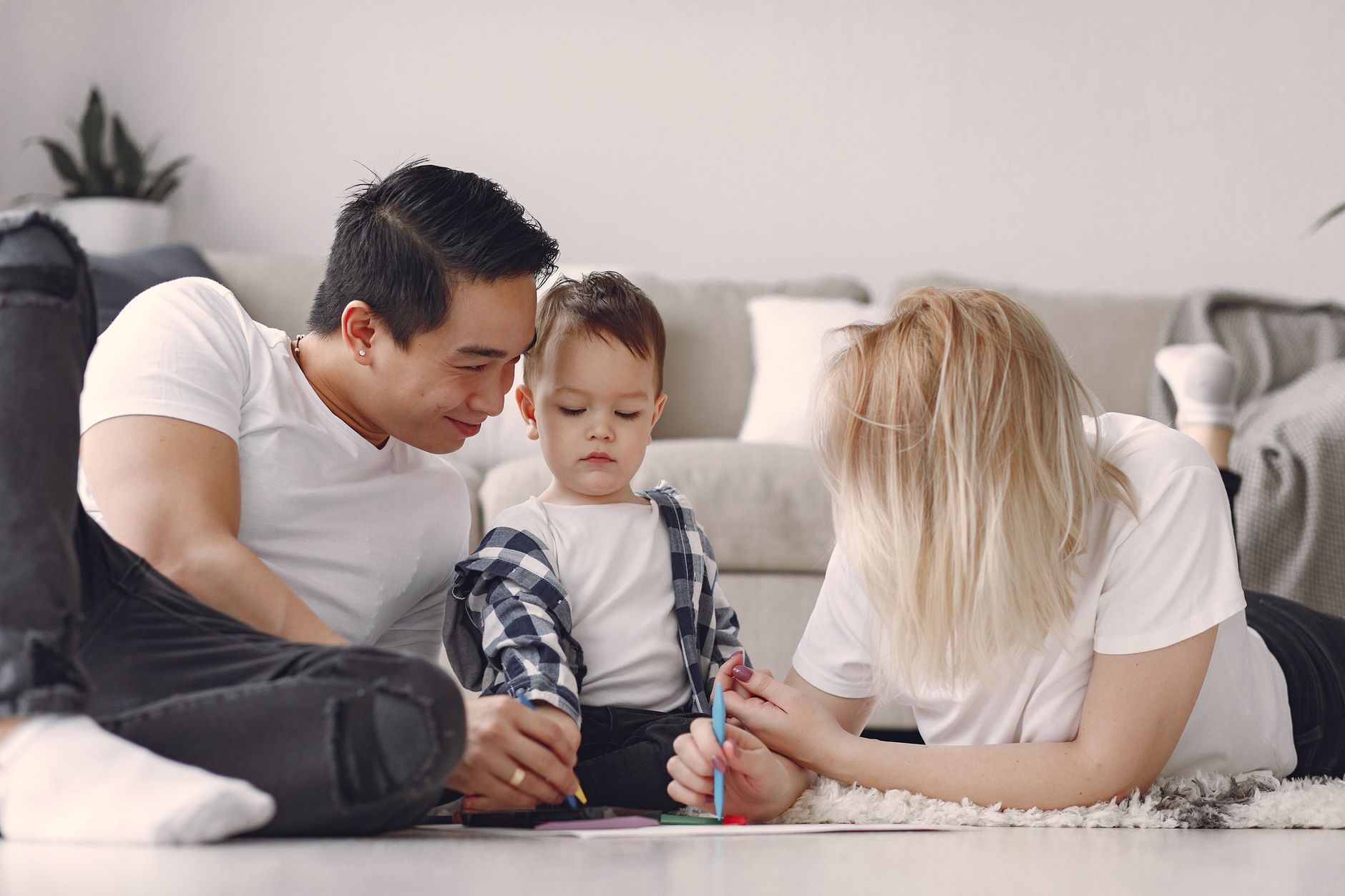 Parents at home with their young child, illustrating family financial protection