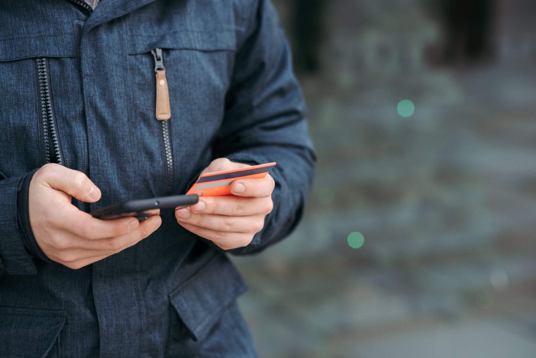 A person making a mobile payment on a smartphone, illustrating peer-to-peer payment apps like Zelle, Venmo, and Cash App