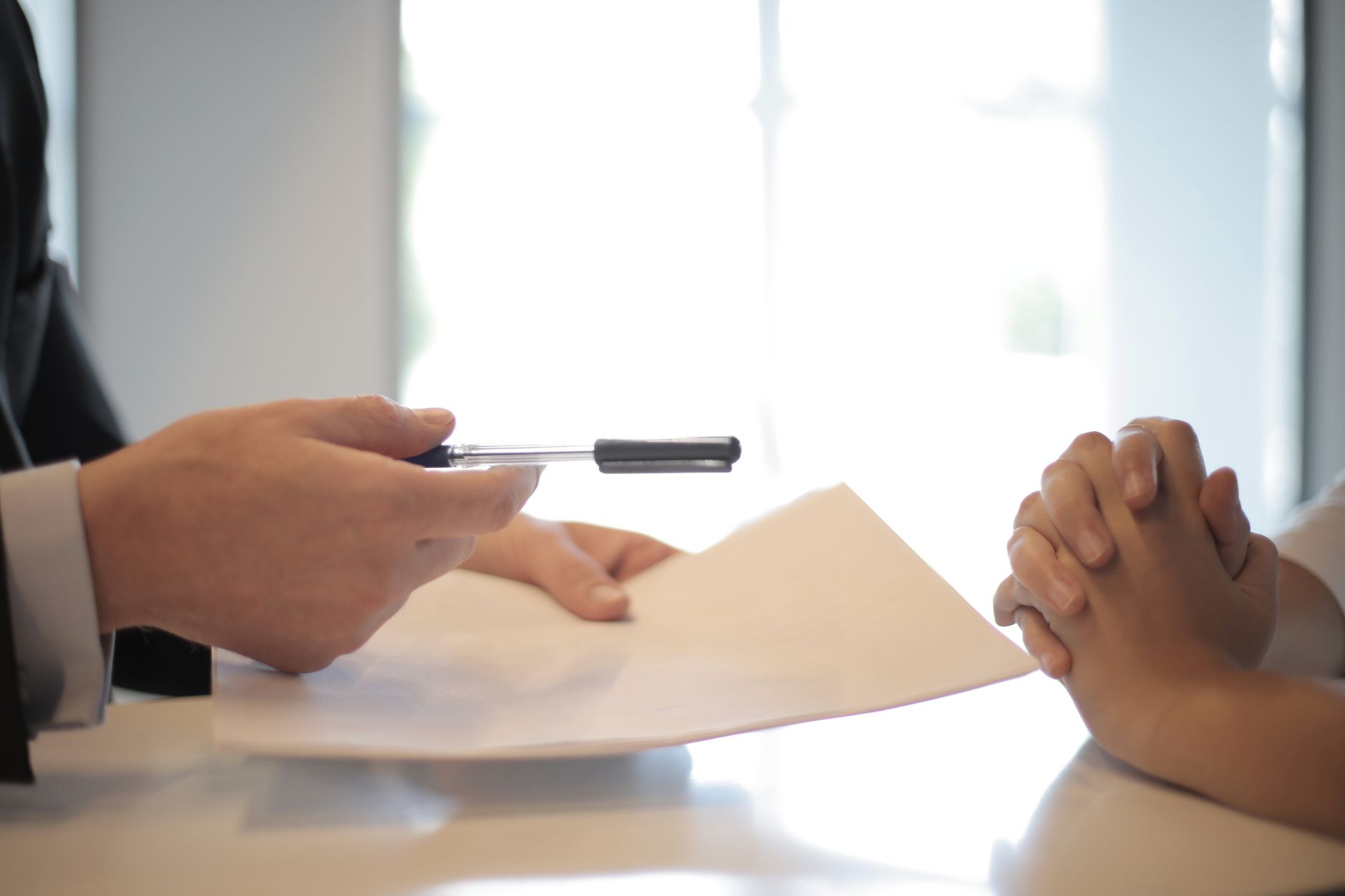 Two people reviewing and signing a loan agreement
