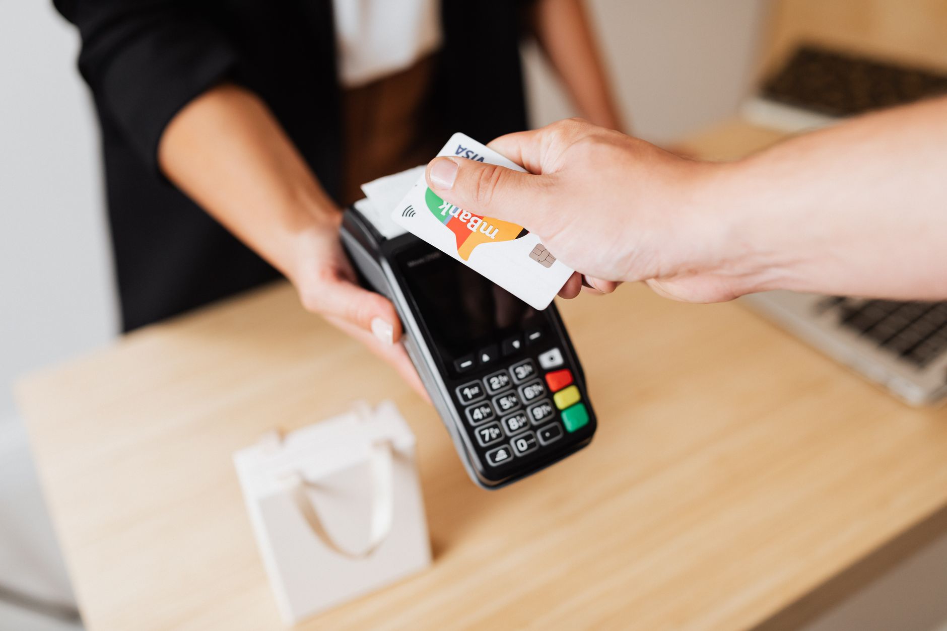 Customer paying with a debit card at a payment terminal