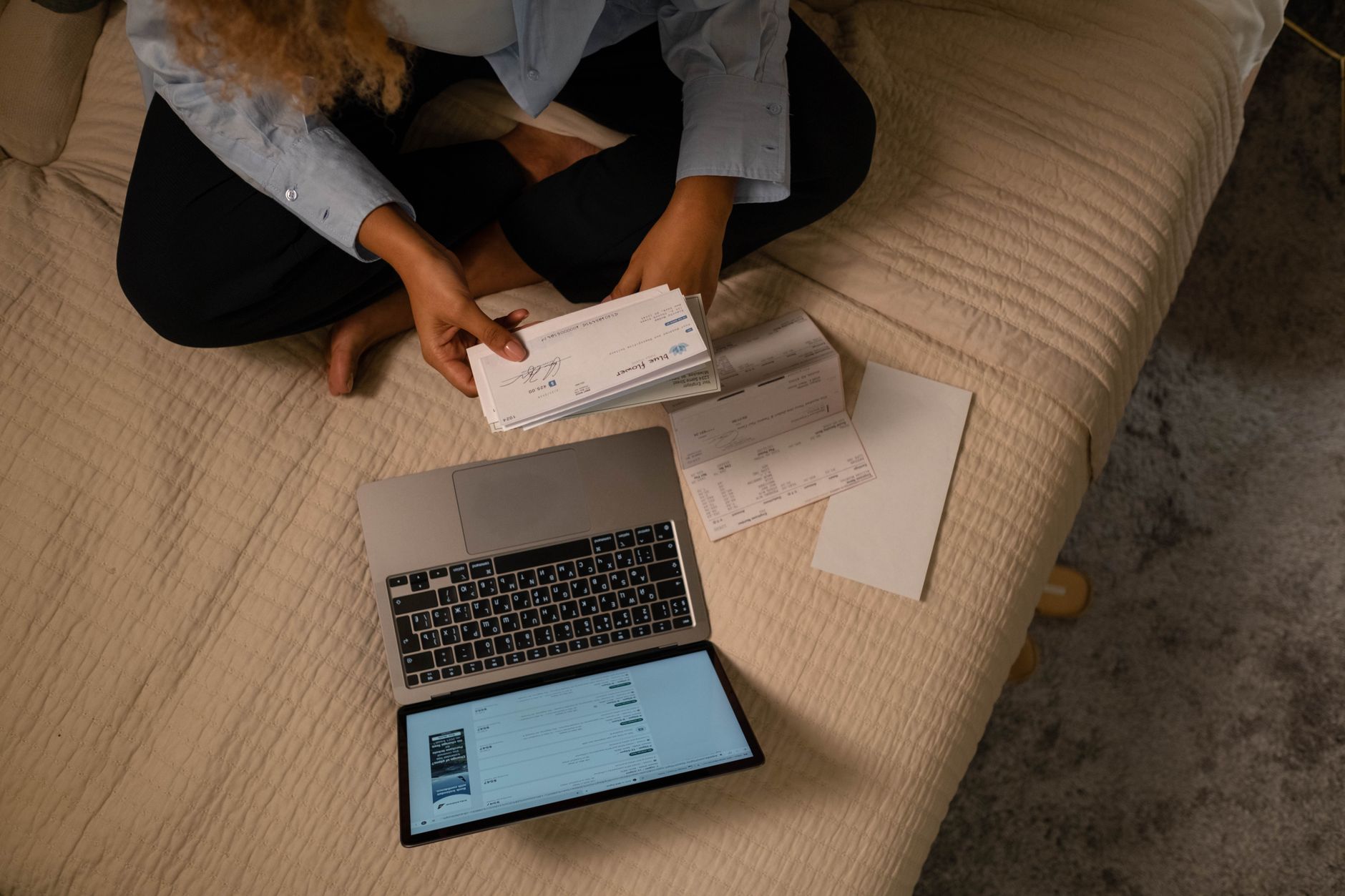 A person checking their bank account balance on a laptop, illustrating how an overdraft line of credit works