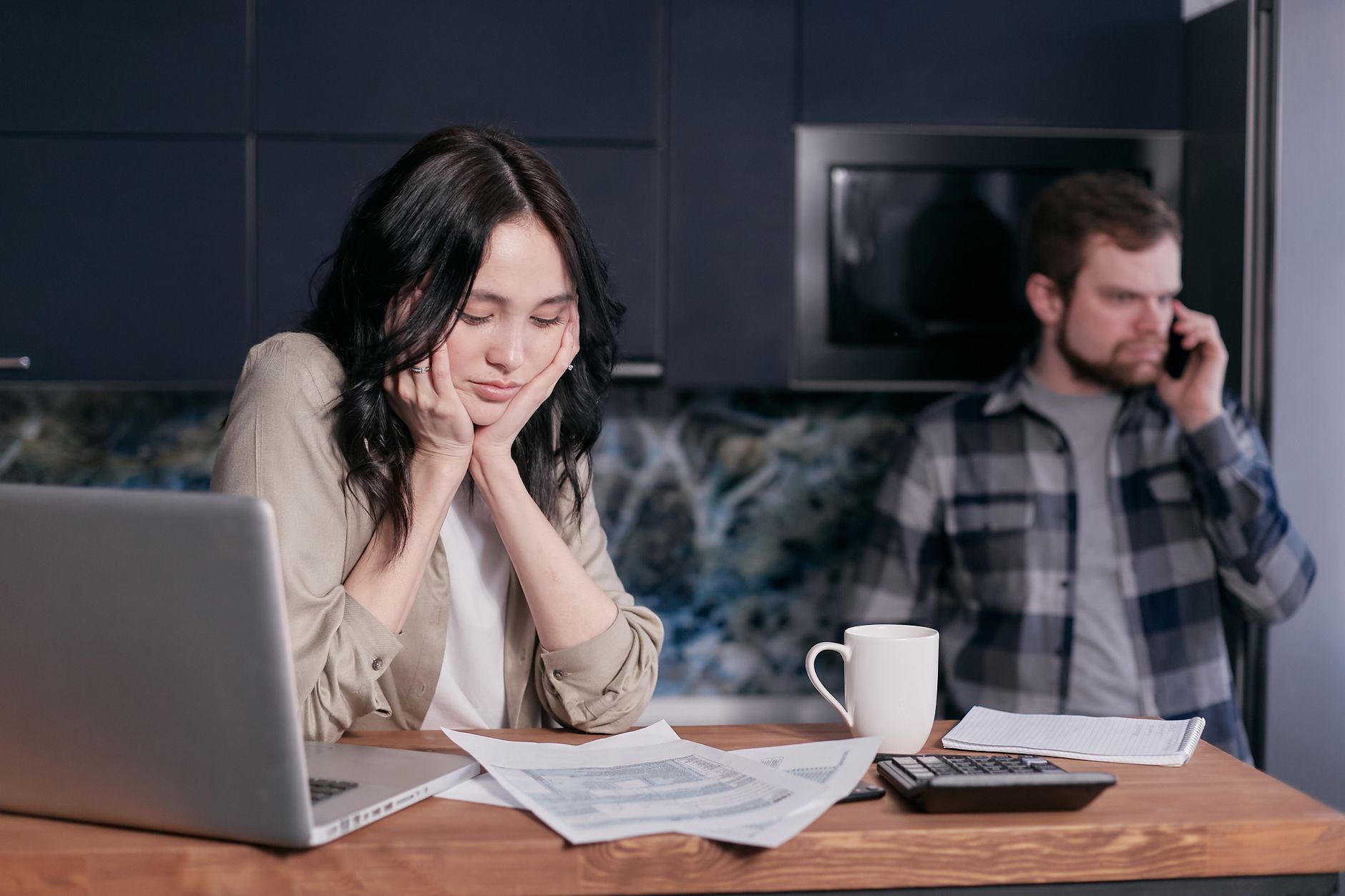 Overdue bill notices next to a phone on a table