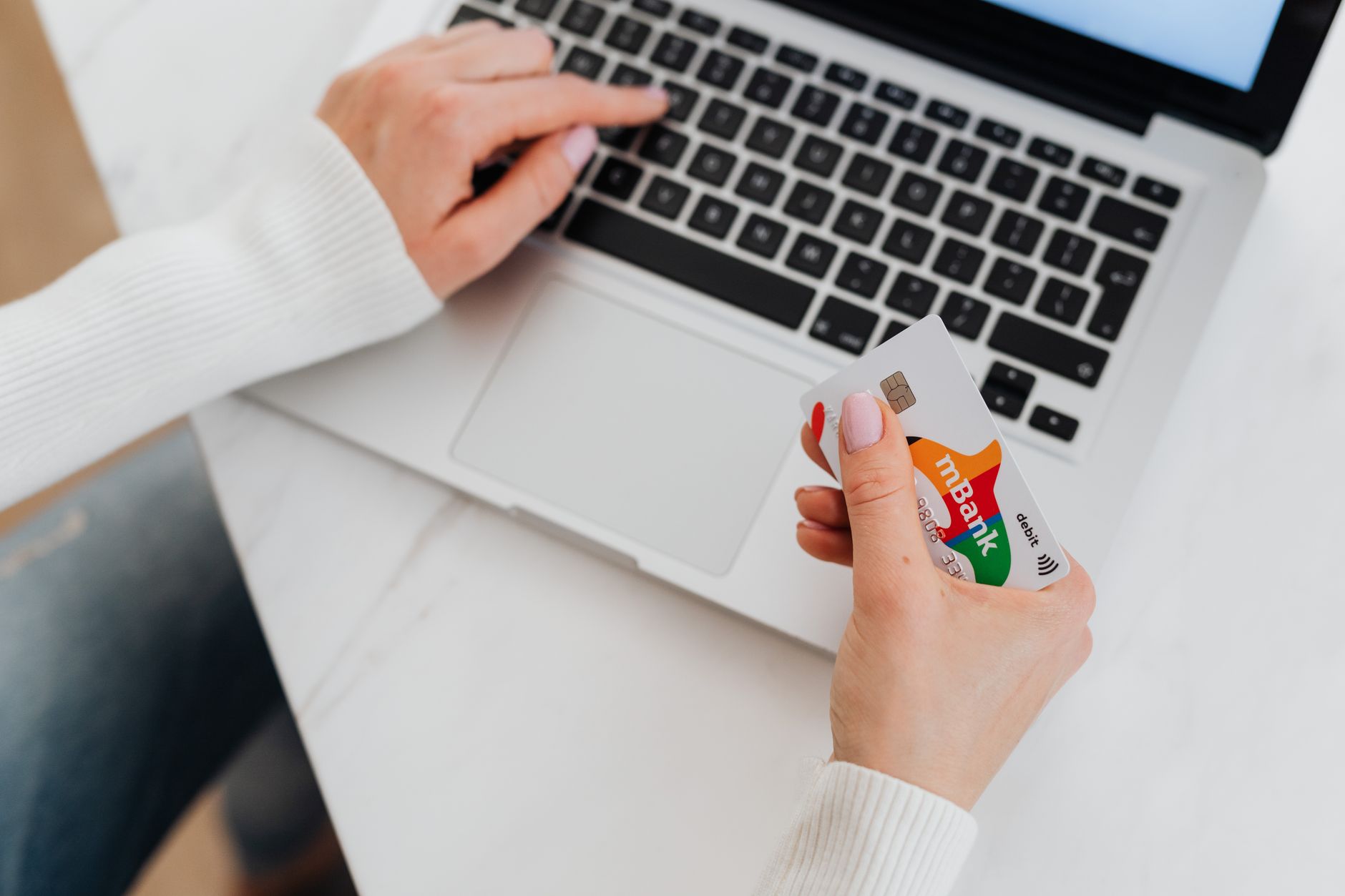 Person making an online bank transfer on a laptop
