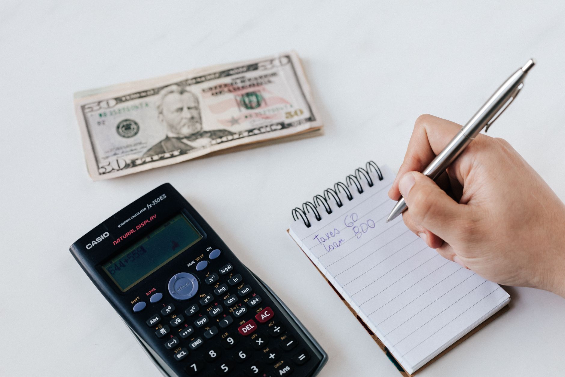Person writing a personal check, illustrating bank check hold rules