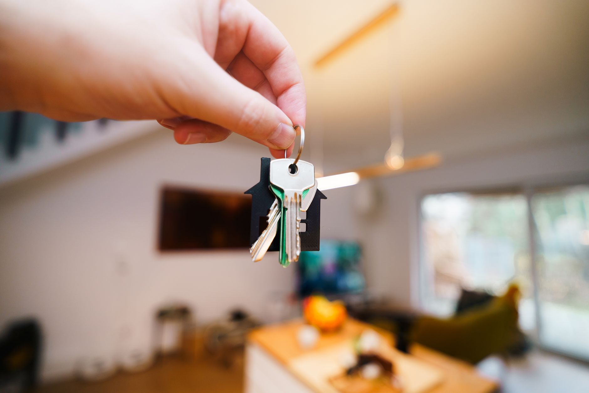 Keys and a lease agreement on a table in a rented apartment