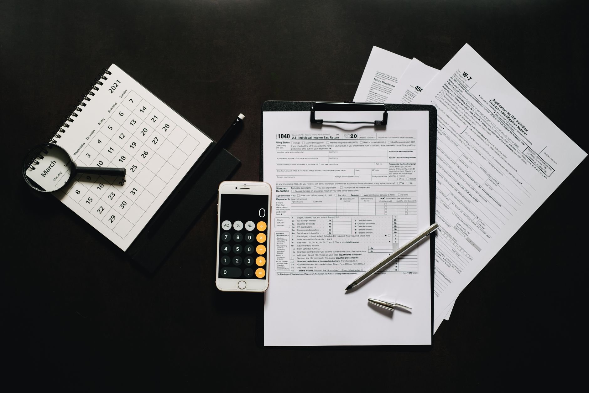 Tax forms and a calculator on a table