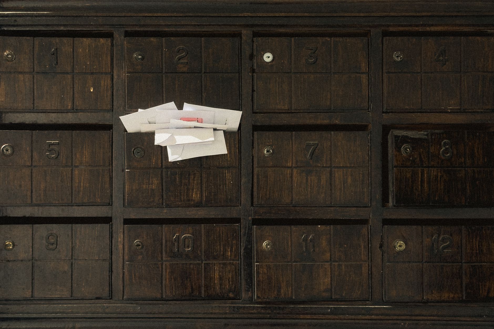 Unopened envelopes in a mailbox, representing unclaimed property notices