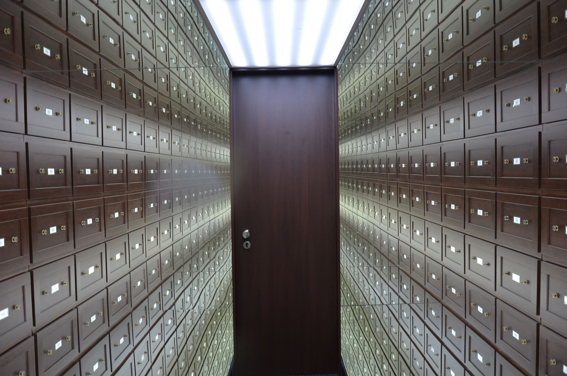Rows of safe deposit boxes inside a bank vault