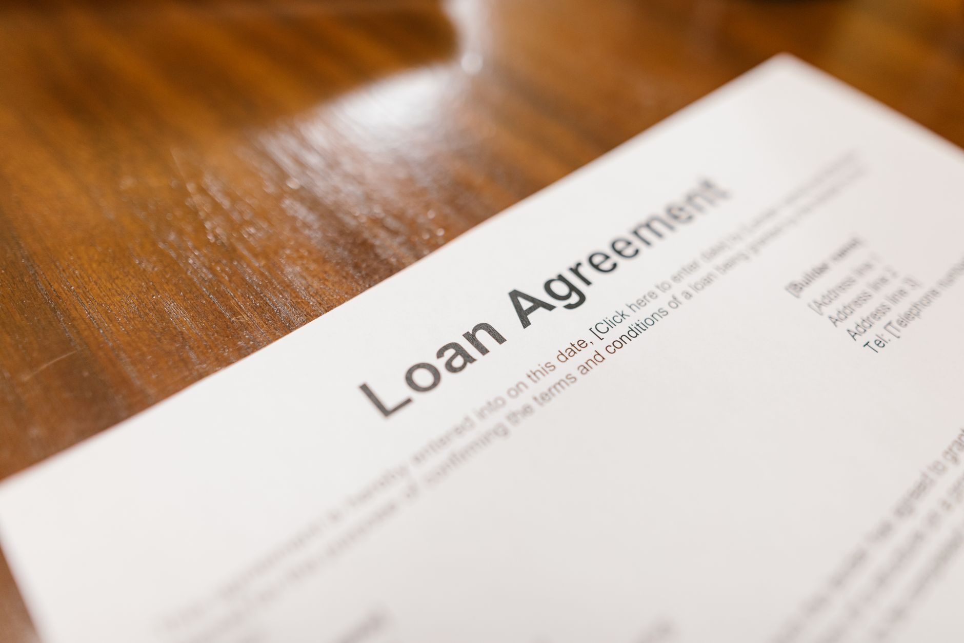 A person reviewing loan disclosure paperwork before signing a credit agreement