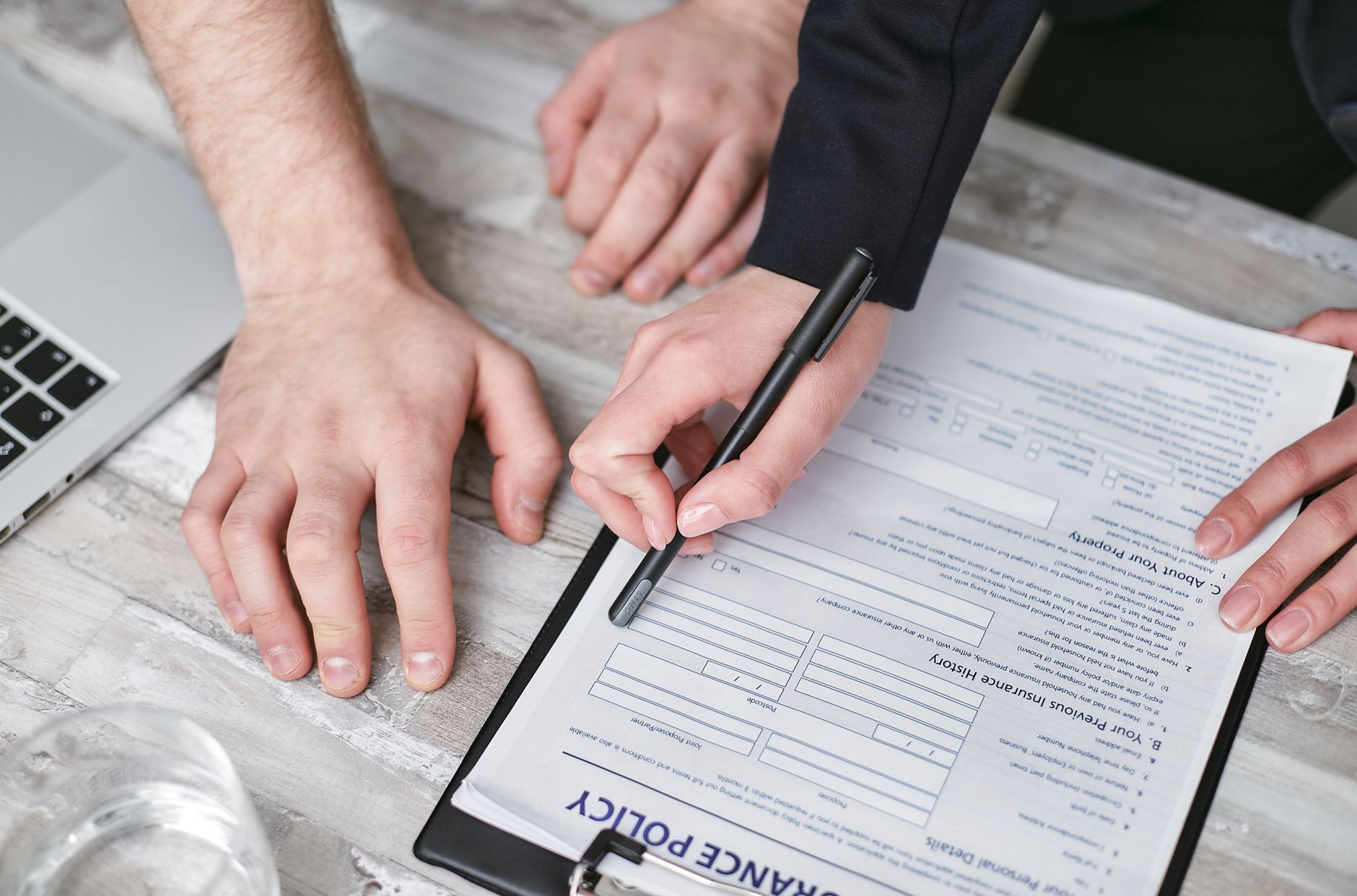 Insurance policy paperwork and a pen on a desk