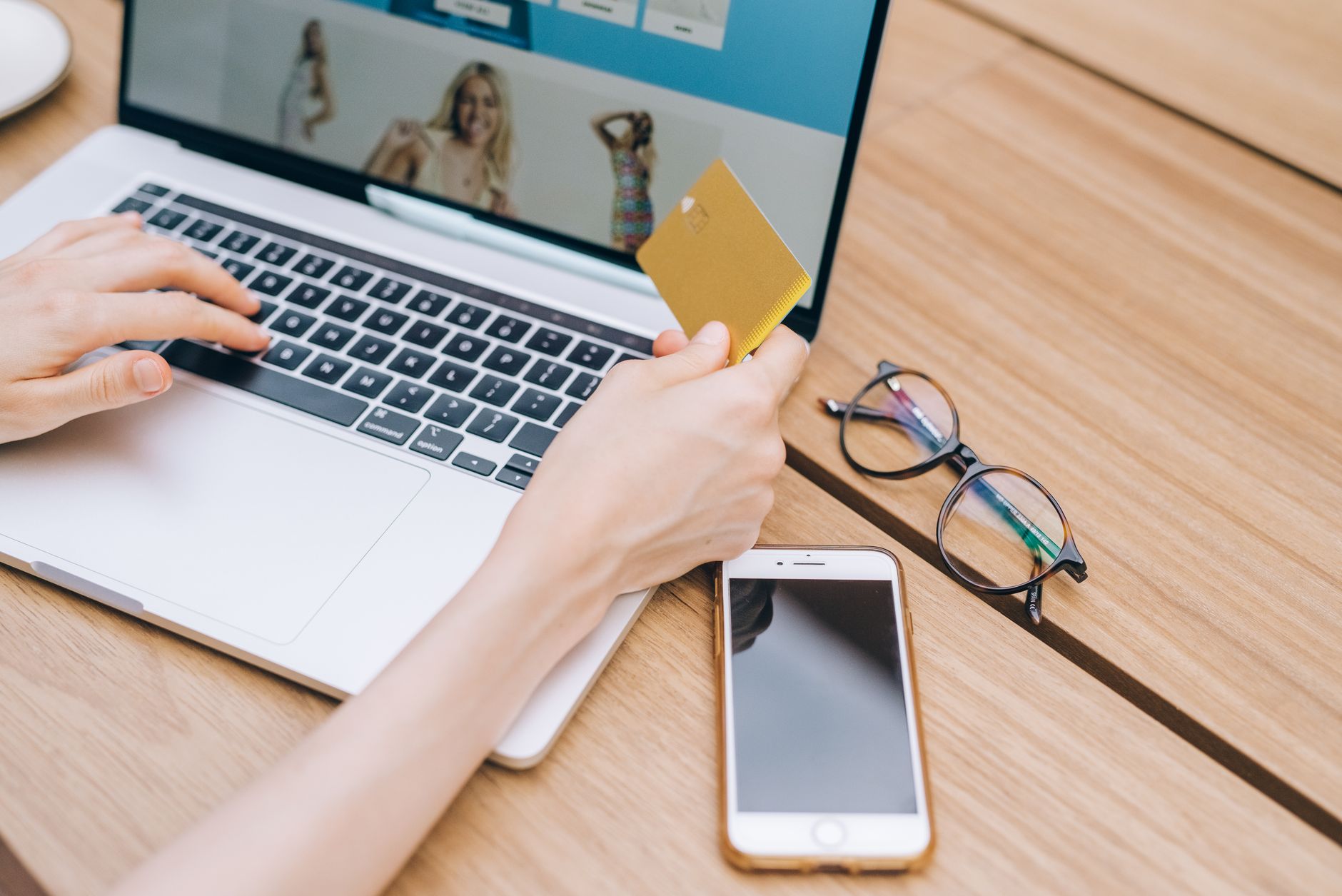 Shopper making an online purchase with a phone and payment card