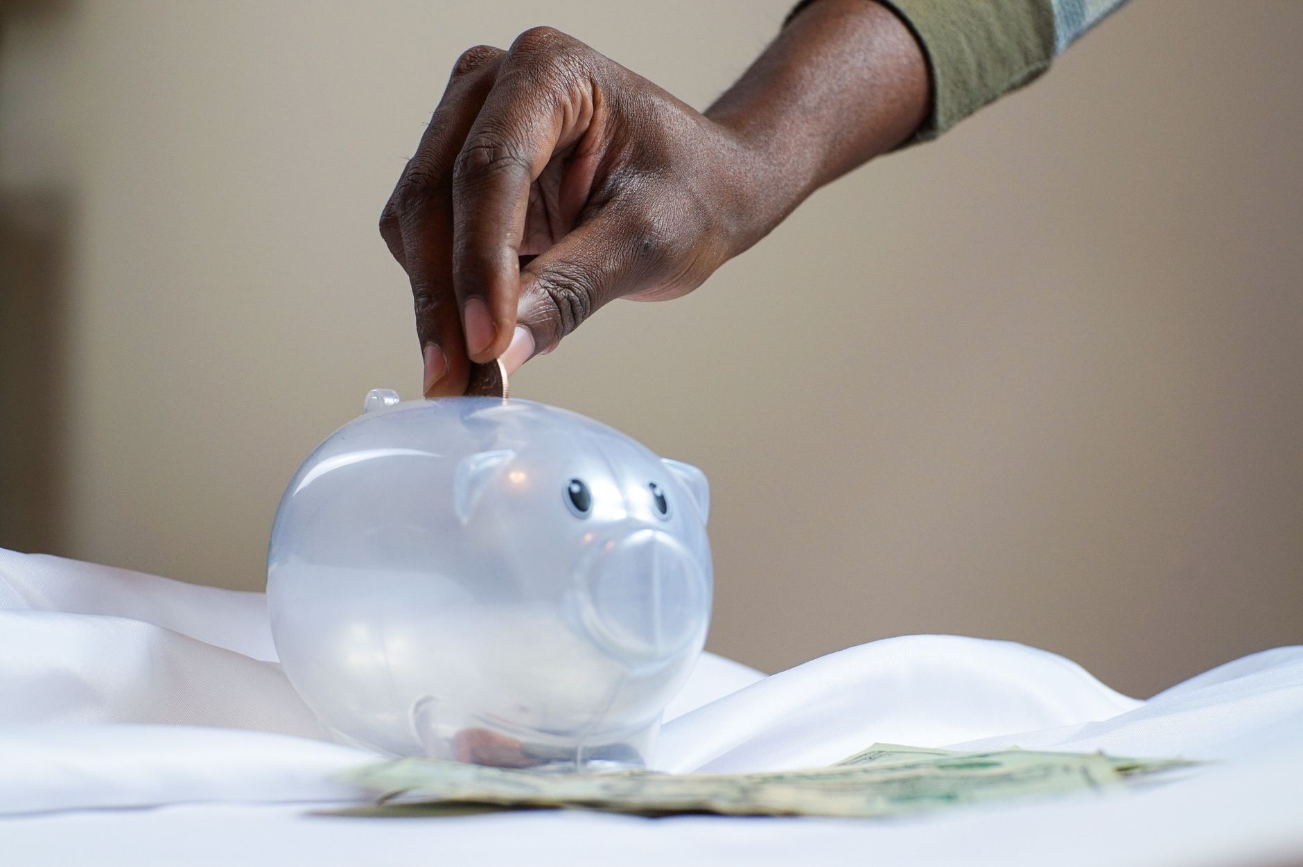 Coins and a savings jar representing a credit union share savings account