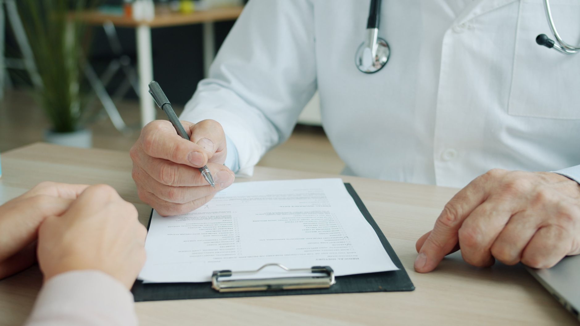 Health insurance paperwork, a stethoscope and a calculator representing health savings account eligibility rules
