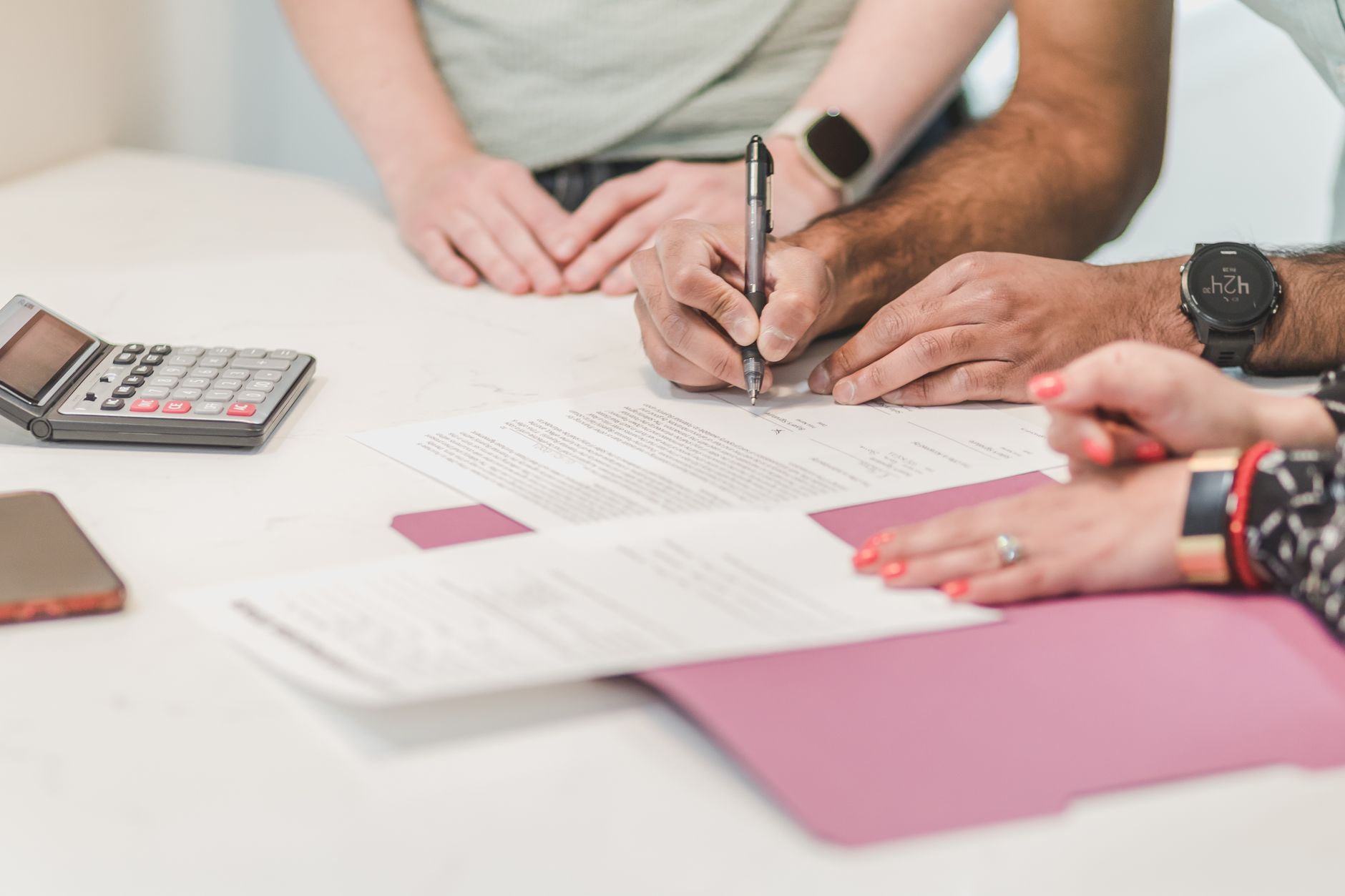 Health insurance enrollment paperwork and a calculator on a desk