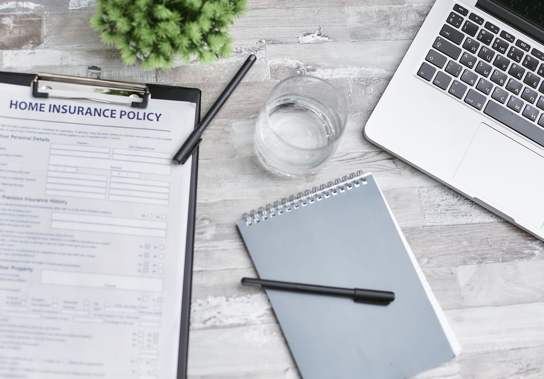 Health insurance enrollment paperwork on a desk, illustrating self-funded employer health plans