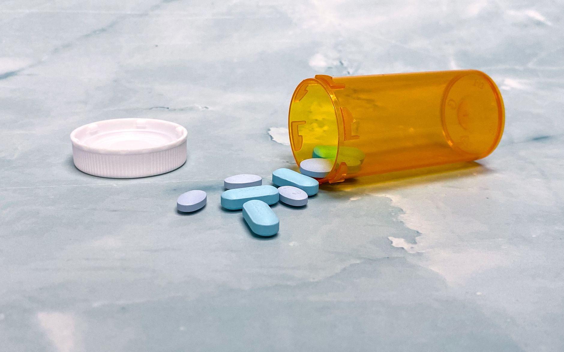 Prescription pill bottles on a pharmacy counter, illustrating Medicare Part D 2026 cost changes