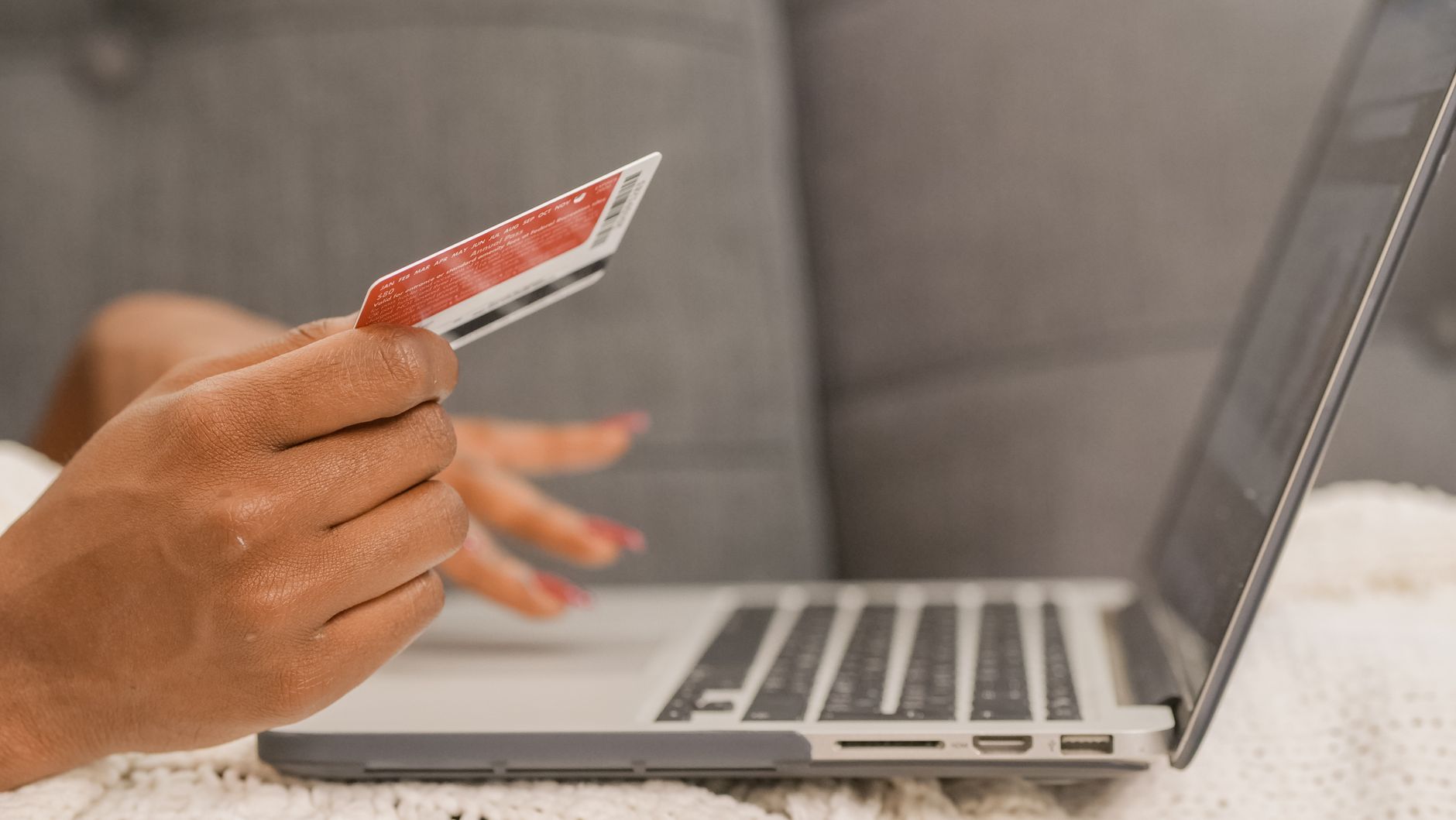 Person paying online from a bank account at checkout on a laptop
