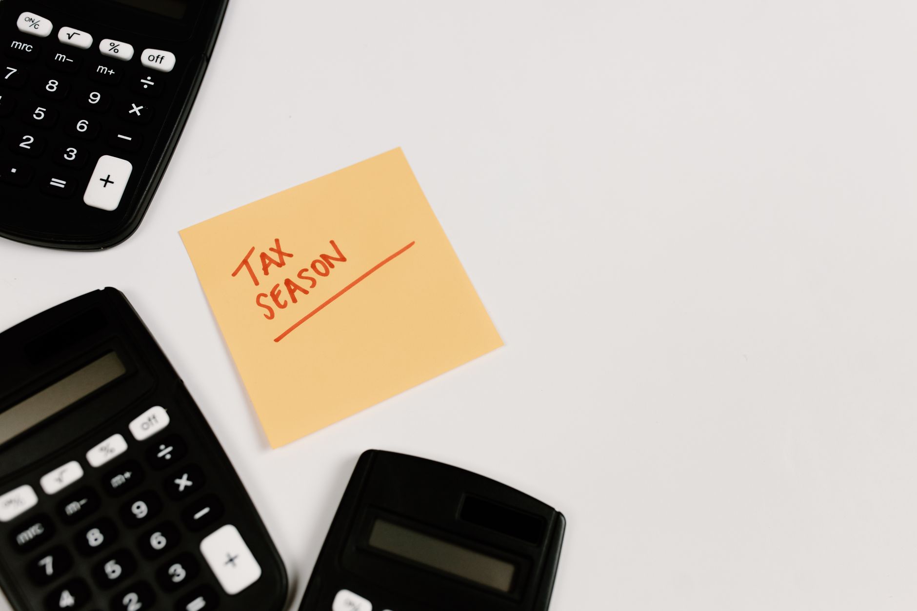 Pay stub and calculator on a desk illustrating pre-tax payroll deductions