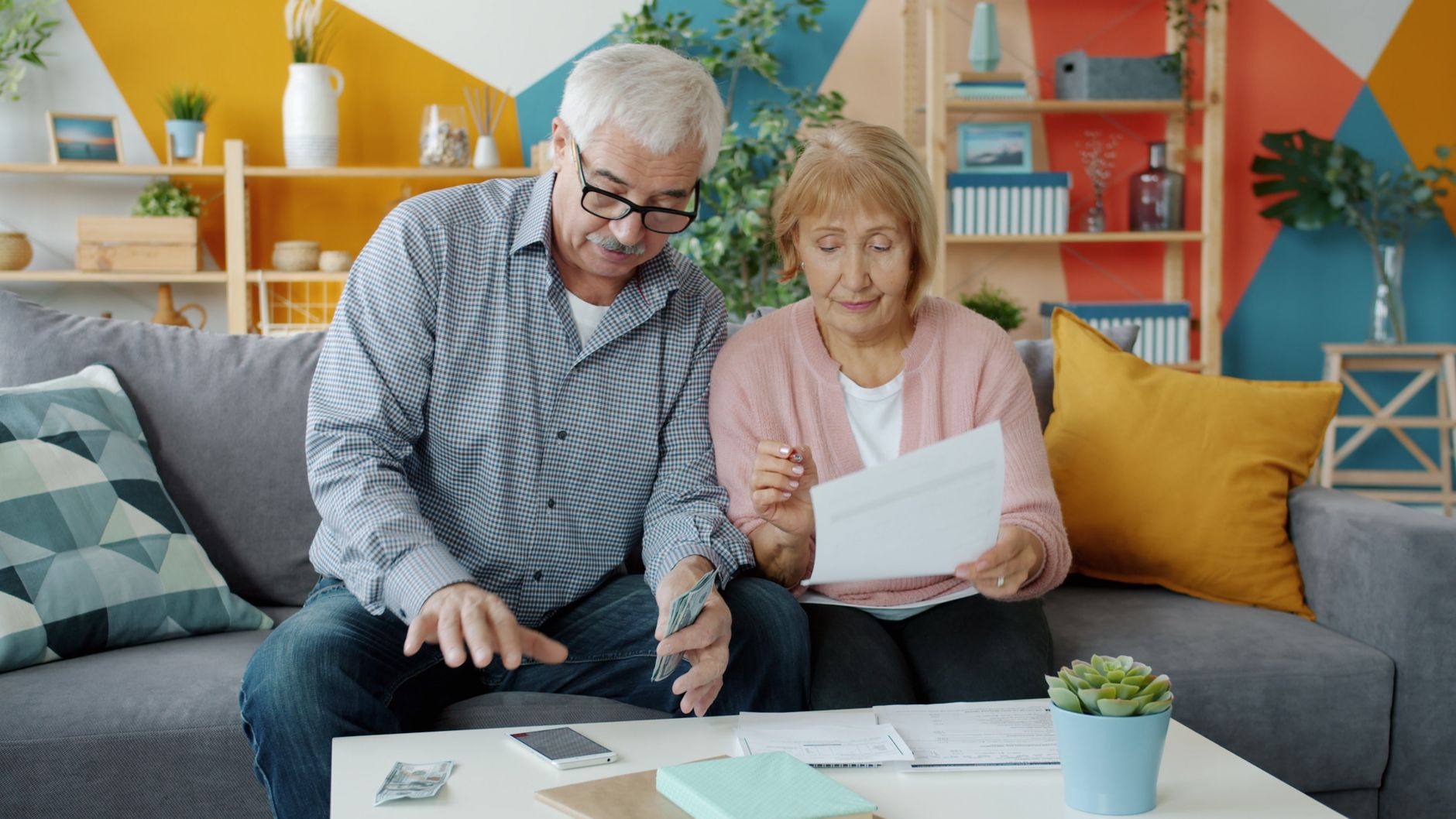 Older adult reviewing retirement account paperwork at a desk