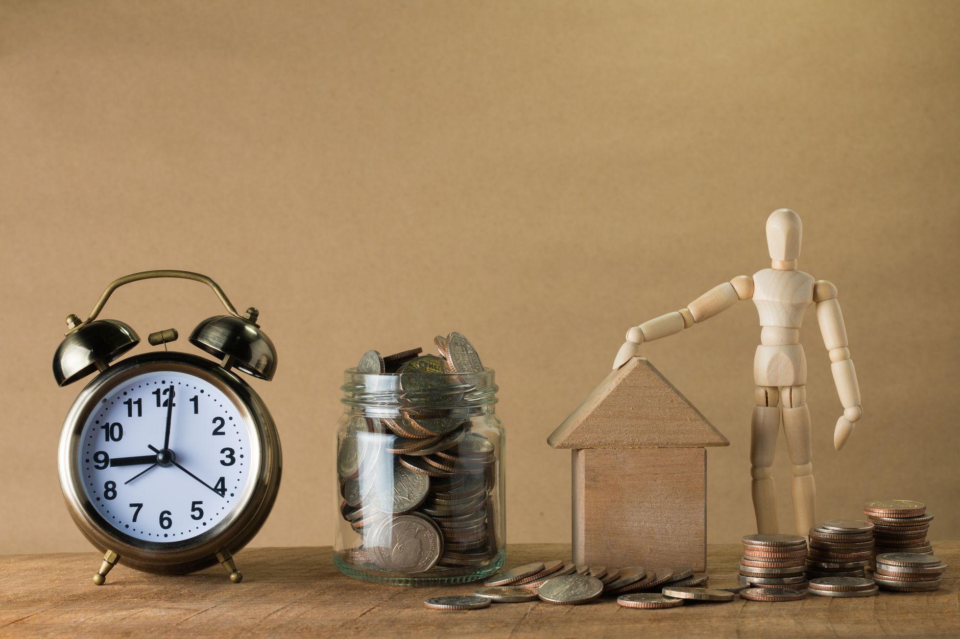 Coins and a savings jar representing retirement contributions