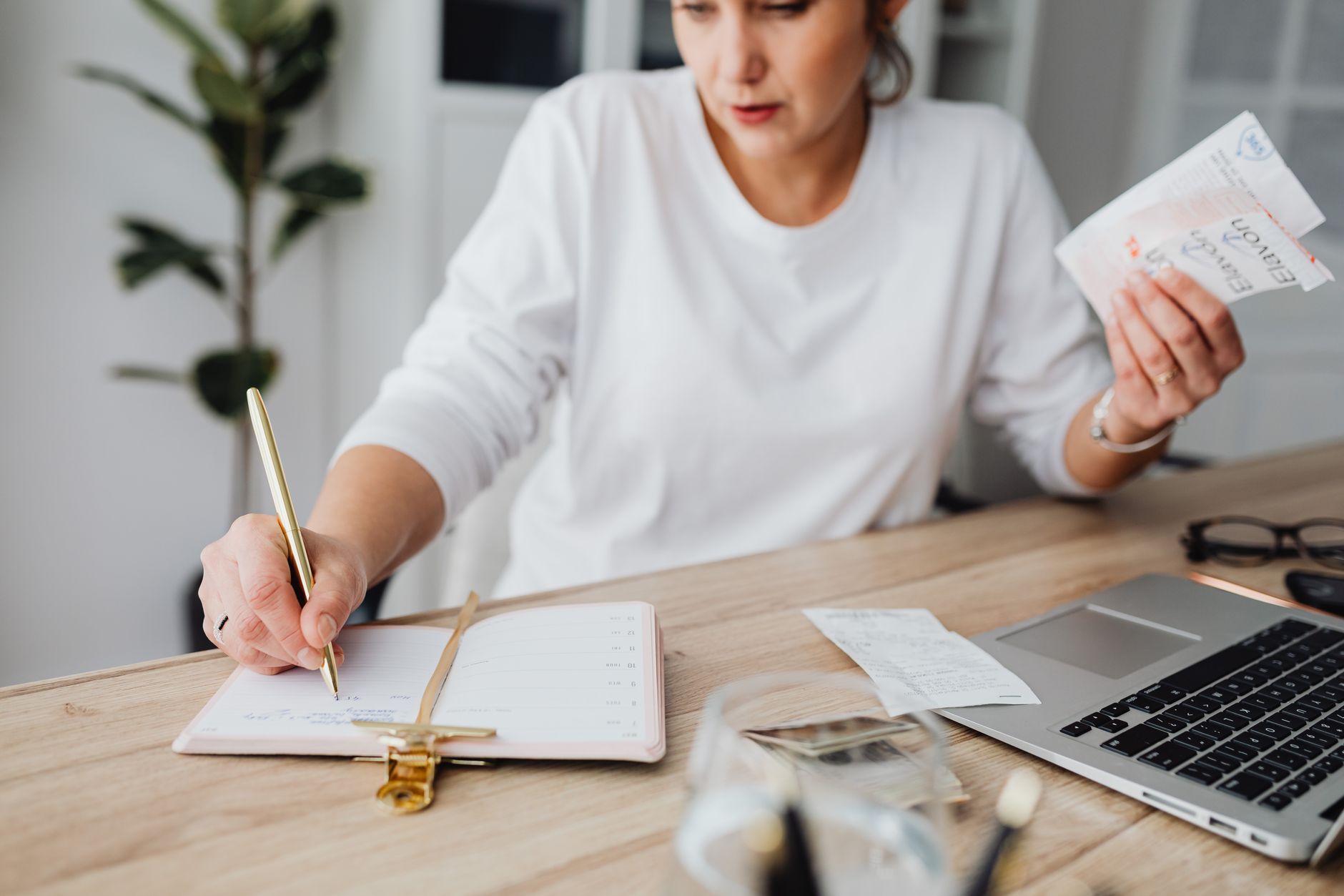 Self-employed worker reviewing retirement paperwork and finances at a home office desk
