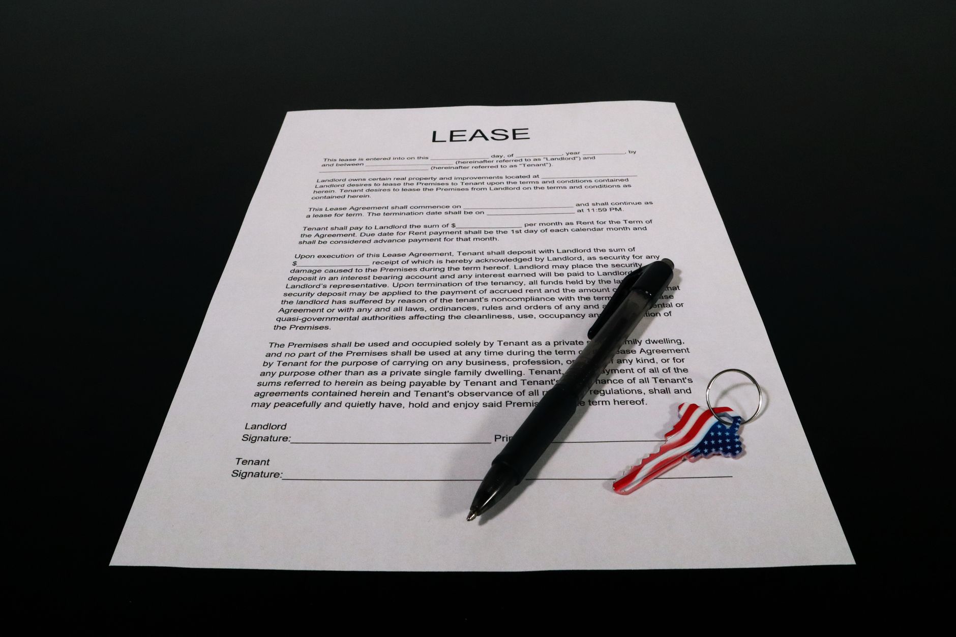 Rental application paperwork and apartment keys on a table