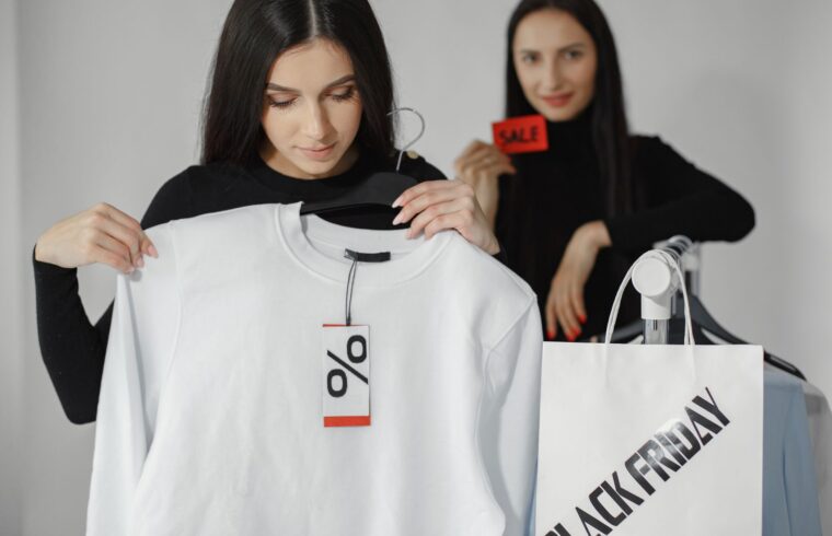 Shopper holding a shirt with a discount tag, illustrating how Black Friday doorbuster sales work