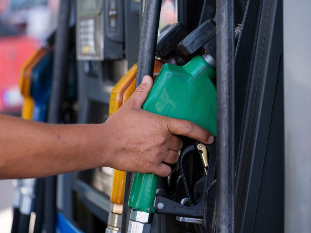 Driver paying with a card at a gas station pump