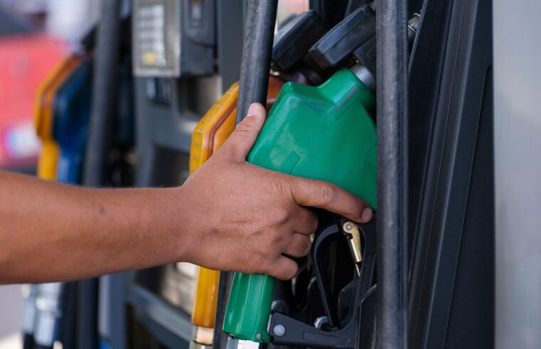 Driver paying with a card at a gas station pump