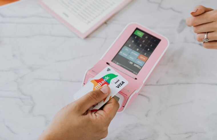Customer tapping a debit card on a store payment terminal