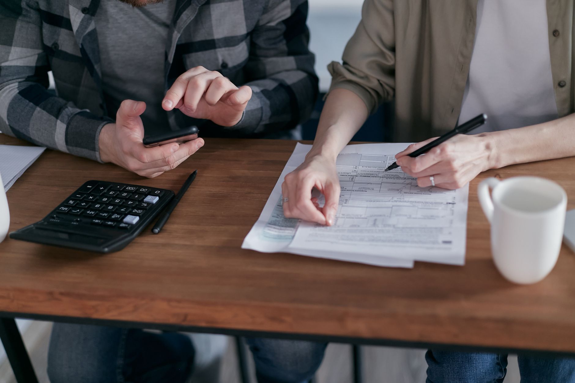 Retired couple reviewing tax paperwork at a kitchen table