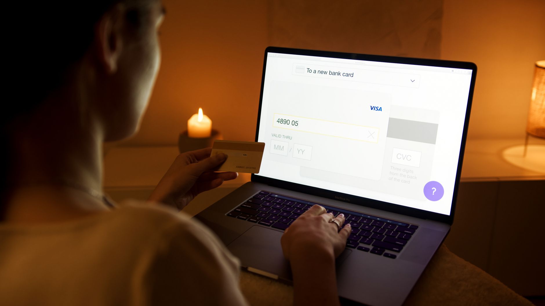 Person reviewing an online bank transfer on a laptop